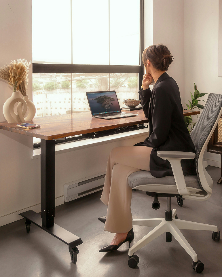 Professional working by a desk in a bright office