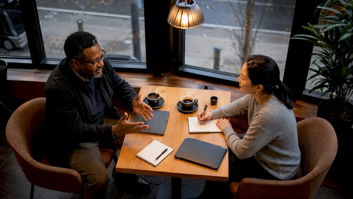 Manager and employee in performance review meeting conversation