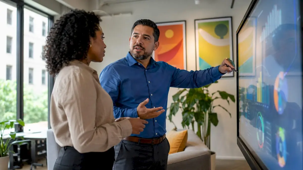 Manager and colleague discussing AI assessment data